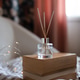 Aroma liquid glass bottle diffuser with wooden sticks on stack of old paper books in living room Aroma liquid glass bottle diffuser with wooden sticks on stack of old paper books in living room - PhotoDune Item for Sale