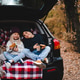 Cute children having picnic in car trunk sitting on checkered blanket in woods over autumn leaves. Cute children having picnic in car trunk sitting on checkered blanket in woods over autumn leaves. - PhotoDune Item for Sale