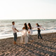 Happy family with two kid girls running at beach over sea outdoors Happy family with two kid girls running at beach over sea outdoors - PhotoDune Item for Sale