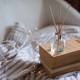 Aroma liquid glass bottle diffuser with wooden sticks on stack of old paper books in living room. Aroma liquid glass bottle diffuser with wooden sticks on stack of old paper books in living room. - PhotoDune Item for Sale