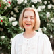Smiling senior woman 60-65 year old with short blonde hair posing over blooming rose bushes Smiling senior woman 60-65 year old with short blonde hair posing over blooming rose bushes - PhotoDune Item for Sale