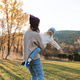 Happy women having fun with child girl 3-4 year old wearing knitted sweaters and hat over nature Happy women having fun with child girl 3-4 year old wearing knitted sweaters and hat over nature - PhotoDune Item for Sale