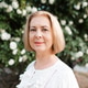Smiling senior woman 60-65 year old with short blonde hair posing over blooming rose bushes Smiling senior woman 60-65 year old with short blonde hair posing over blooming rose bushes - PhotoDune Item for Sale