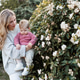 Happy stylish mother holding baby girl 1 year old wearing knitted sweaters Happy stylish mother holding baby girl 1 year old wearing knitted sweaters - PhotoDune Item for Sale