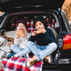Cute children having picnic in car trunk sitting on checkered blanket in woods over autumn leaves. Cute children having picnic in car trunk sitting on checkered blanket in woods over autumn leaves. - PhotoDune Item for Sale