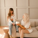 Mother eating birthday cake with child girl daughter sitting on sofa in room Mother eating birthday cake with child girl daughter sitting on sofa in room - PhotoDune Item for Sale