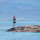 Small white and black lighthouse on a rocky island in the Lysefjord against misty mountains in Norwa Small white and black lighthouse on a rocky island in the Lysefjord against misty mountains in Norwa - PhotoDune Item for Sale