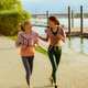 Friends run along the riverside path during the evening in a sunny weather Friends run along the riverside path during the evening in a sunny weather - PhotoDune Item for Sale