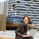 Woman works on laptop outside modern building in city Woman works on laptop outside modern building in city - PhotoDune Item for Sale