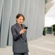 Woman standing outside modern building while using smartphone in city Woman standing outside modern building while using smartphone in city - PhotoDune Item for Sale