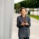 Business professional walking and using smartphone near waterfront path Business professional walking and using smartphone near waterfront path - PhotoDune Item for Sale