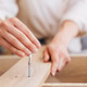 Woman assembling furniture using an Allen wrench tool Woman assembling furniture using an Allen wrench tool - PhotoDune Item for Sale