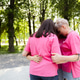 Diverse group of women wearing stylish pink t shirt holding hands in circle on the street Diverse group of women wearing stylish pink t shirt holding hands in circle on the street - PhotoDune Item for Sale