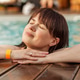 Woman relaxing in swimming pool enjoying wellness spa vacation Woman relaxing in swimming pool enjoying wellness spa vacation - PhotoDune Item for Sale