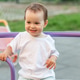 Smiling Toddler Riding Playground Carousel During Outdoor Play Smiling Toddler Riding Playground Carousel During Outdoor Play - PhotoDune Item for Sale
