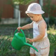 Toddler Exploring Vegetable Garden with Watering Can During Summer Toddler Exploring Vegetable Garden with Watering Can During Summer - PhotoDune Item for Sale
