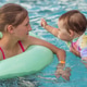Toddler Swimming with Older Sister in Pool During Summer Vacation Toddler Swimming with Older Sister in Pool During Summer Vacation - PhotoDune Item for Sale