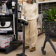Woman choosing a new cordless vacuum cleaner in a retail store, planning home cleaning Woman choosing a new cordless vacuum cleaner in a retail store, planning home cleaning - PhotoDune Item for Sale