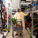 Woman selecting gardening equipment and tools from shelves in a retail hardware store aisle Woman selecting gardening equipment and tools from shelves in a retail hardware store aisle - PhotoDune Item for Sale