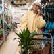 Senior woman talking on smartphone, smiling while shopping for plants and gardening tools Senior woman talking on smartphone, smiling while shopping for plants and gardening tools - PhotoDune Item for Sale