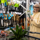 Senior woman smiling, holding gardening tools, standing by shelves in a hardware store Senior woman smiling, holding gardening tools, standing by shelves in a hardware store - PhotoDune Item for Sale