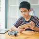Asian boy learning and studying the work of technology robots.homeschool and science for tech projec Asian boy learning and studying the work of technology robots.homeschool and science for tech projec - PhotoDune Item for Sale