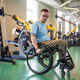 Post accident athlete. Determined disabled man in wheelchair training arms and shoulders with weight Post accident athlete. Determined disabled man in wheelchair training arms and shoulders with weight - PhotoDune Item for Sale