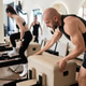 People exercising on pilates reformer during gym class People exercising on pilates reformer during gym class - PhotoDune Item for Sale