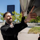 Happy man closing car trunk in urban environment Happy man closing car trunk in urban environment - PhotoDune Item for Sale