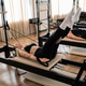 Women exercising pilates reformer machine for core strength Women exercising pilates reformer machine for core strength - PhotoDune Item for Sale