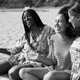 Happy multiracial young women drinking fresh homemade lemonade while doing picnic on the beach Happy multiracial young women drinking fresh homemade lemonade while doing picnic on the beach - PhotoDune Item for Sale