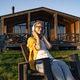 Relaxing Woman in Front of Cabin Relaxing Woman in Front of Cabin - PhotoDune Item for Sale