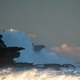 Dramatic ocean waves crashing against rugged cliffs at dusk Dramatic ocean waves crashing against rugged cliffs at dusk - PhotoDune Item for Sale
