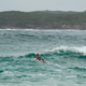 Female surfer paddling out into ocean waves Female surfer paddling out into ocean waves - PhotoDune Item for Sale