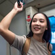 Asian woman holding the overhead strap while traveling on subway train. Asian woman holding the overhead strap while traveling on subway train. - PhotoDune Item for Sale