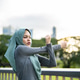 Asian Muslim woman stretching body while exercise on the rooftop garden. Asian Muslim woman stretching body while exercise on the rooftop garden. - PhotoDune Item for Sale