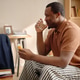 Black Man Taking Medication at Home for Fatigue Recovery Black Man Taking Medication at Home for Fatigue Recovery - PhotoDune Item for Sale