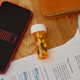 Smartphone Showing Low Battery near Pills for Digital Fatigue Concept Smartphone Showing Low Battery near Pills for Digital Fatigue Concept - PhotoDune Item for Sale