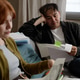 Adult Couple Reviewing Bills and Budgeting at Home Adult Couple Reviewing Bills and Budgeting at Home - PhotoDune Item for Sale