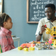 Black Man Teacher Guiding Children in Robotics Stem Lesson Black Man Teacher Guiding Children in Robotics Stem Lesson - PhotoDune Item for Sale