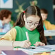 Schoolgirl Wearing Glasses Drawing in Classroom for Education Schoolgirl Wearing Glasses Drawing in Classroom for Education - PhotoDune Item for Sale