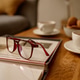 Reading Glasses Resting on Book Beside Tea for Cozy Home Lifestyle Reading Glasses Resting on Book Beside Tea for Cozy Home Lifestyle - PhotoDune Item for Sale
