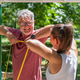 Senior man performing an upper body resistance band workout with a fitness coach to improve shoulder Senior man performing an upper body resistance band workout with a fitness coach to improve shoulder - PhotoDune Item for Sale