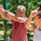 Senior man completing a functional resistance band exercise with a fitness coach to improve coordina Senior man completing a functional resistance band exercise with a fitness coach to improve coordina - PhotoDune Item for Sale