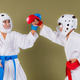 Karate practitioner raises a red gloved punch toward the opponent's head while the defender intercep Karate practitioner raises a red gloved punch toward the opponent's head while the defender intercep - PhotoDune Item for Sale