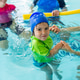 Little boy in a blue swim cap practices water movement assisted by two instructors in an indoor pool Little boy in a blue swim cap practices water movement assisted by two instructors in an indoor pool - PhotoDune Item for Sale