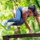 Fit athletic woman performing explosive vault over wooden obstacle in park, high intensity functiona Fit athletic woman performing explosive vault over wooden obstacle in park, high intensity functiona - PhotoDune Item for Sale