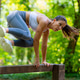 Fit woman captured mid air during vault exercise, demonstrating body control, balance and explosive Fit woman captured mid air during vault exercise, demonstrating body control, balance and explosive - PhotoDune Item for Sale