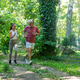 Senior man jogging through a forest park with a fitness coach to improve cardiovascular fitness, end Senior man jogging through a forest park with a fitness coach to improve cardiovascular fitness, end - PhotoDune Item for Sale