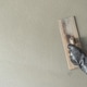 Hand plasterer plastering cement wall background Hand plasterer plastering cement wall background - PhotoDune Item for Sale